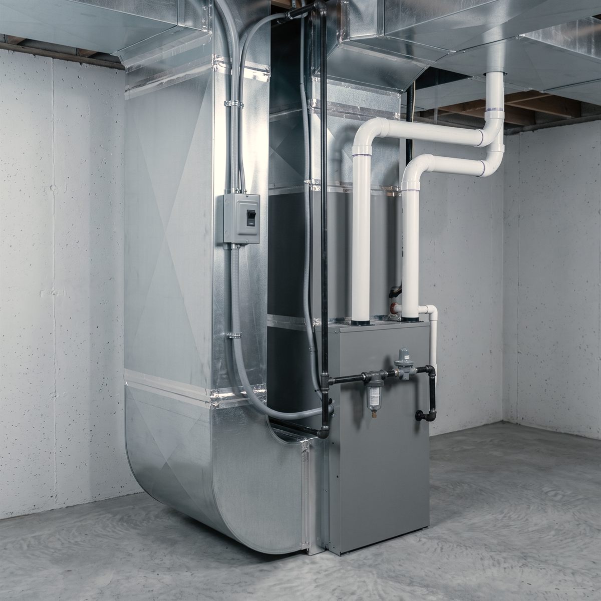 A gas furnace and sheet metal ductwork in a utility room